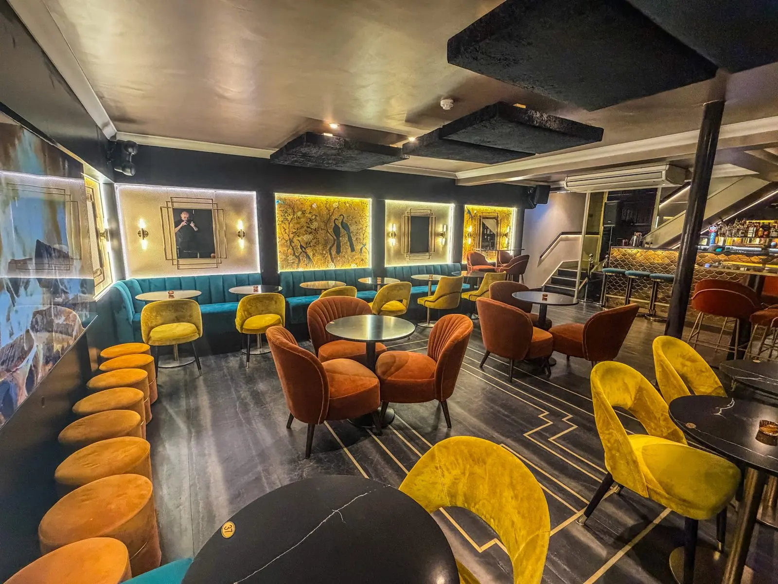The Basement Lounge at Teatro: orange and yellow velvet chairs and lit wall panels